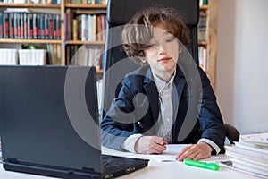 Learning at home, online learning, self quarantine concept. Children doing homework with books, textbooks and with computer online