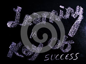 learning is key of success sentence presented on chalkboard concept