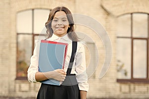 Learning language. Cute smiling child hold book. Little girl school student. Knowledge day. Hooked on learning. School