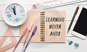 Learning Never Ands is written on a notepad