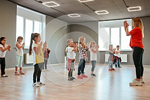 Learning a new dance. Group of little boys and girls dancing while having choreography class in the dance studio. Dance