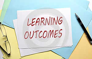LEARNING OUTCOMES text on paper on colorful paper background