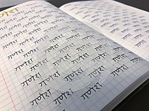 Learning sanskrit devanagari hindi alphabet handwritten in copybook