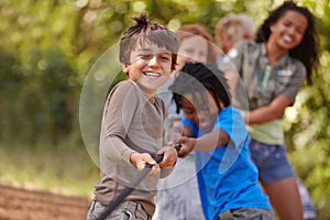 Learning teamwork through play. A group of kids in a tug-of-war game.