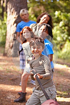 Learning teamwork through play. A group of kids in a tug-of-war game.