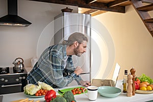 Man watching video tutorials on cooking a salad
