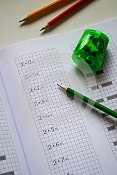 learning to count and write numbers correctly, notebook and pencils