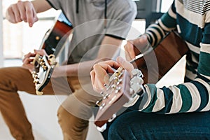 Learning to play the guitar. Music education and extracurricular lessons.