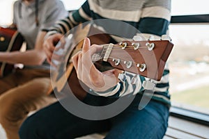 Learning to play the guitar. Music education and extracurricular lessons. Hobbies and enthusiasm for playing guitar and