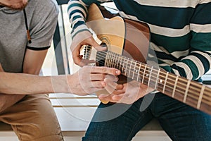 Learning to play the guitar. Music education and extracurricular lessons. Hobbies and enthusiasm for playing guitar and