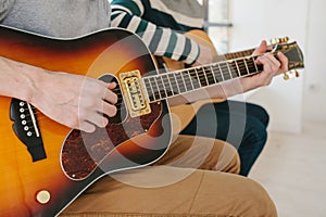 Learning to play the guitar. Music education and extracurricular lessons. Hobbies and enthusiasm for playing guitar and