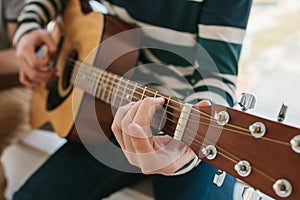 Learning to play the guitar. Music education and extracurricular lessons. Hobbies and enthusiasm for playing guitar and