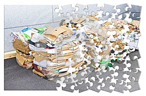 Learning to recycle - concept image in jigsaw puzzle shape - Stacks of paper and cardboard ready to be recycled