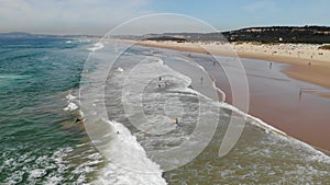 learning to surf on the waves of the ocean or sea Aerial drone view. Flying over