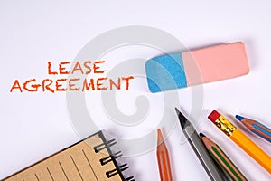 Lease Agreement. Colored pencils and eraser on a white table