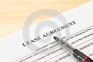 Lease Agreement Contract Document and Pen at Bottom Right Corner