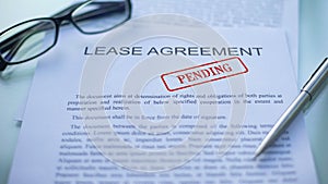 Lease agreement pending, officials hand stamping seal on business document