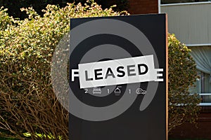 For lease and leased sign on a black display outside of a resedential building photo