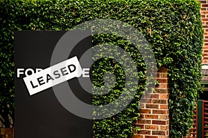 For lease and leased sign on a black display photo