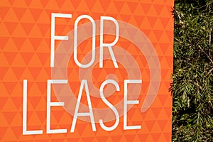 For lease sign on an orange display outside of a resedential building house in Australia. renting and investment property real photo