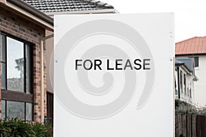 For lease and sign on a white display outside of a residential building