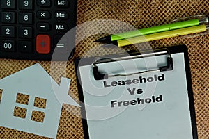 Leasehold Vs Freehold write on a paperwork isolated on Wooden Table photo