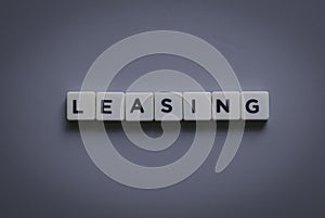 Leasing word made of square letter word on gray background