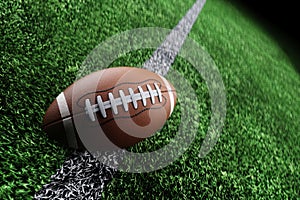 Leather American football ball on the grass of a football field at the stadium. American sport concept, strength, victory. Poster