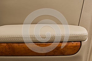 Leather background. Auto door armrest. Modern business car interior detail.