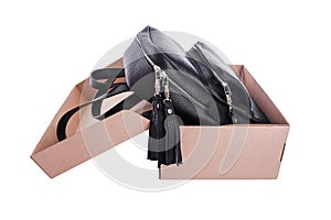 Leather backpack in a cardboard box.