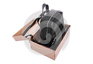 Leather backpack in a cardboard box.