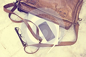Leather bag with blank diary, cell phone