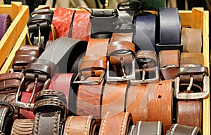 Leather belts handcrafted by skilled artisans with metal buckles are available for purchase at the leather goods store