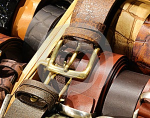 Leather belts handcrafted by skilled artisans with metal buckles are available for purchase at the leather goods store