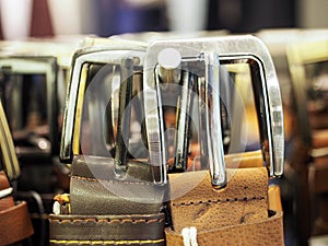 Leather belts on the hanger in the store