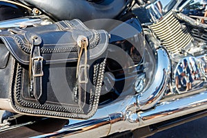 Leather biker bag on motorcycle close-up. Concept travel on a motorcycle