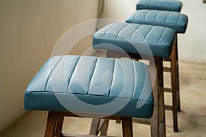 Leather blue stool wooden chair in cafe