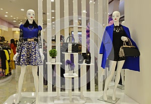 Leather boots and female mannequin with handbag in a fashion shop window