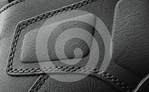 Leather boots stitched with thread close up