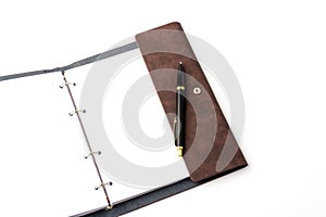 Leather-bound business notebook with a Parker pen on a white background. Business concept