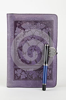 Leather bound purple journal and pen