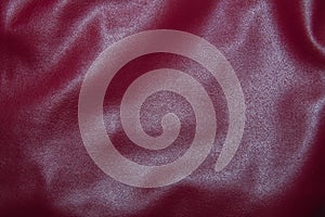 Leather burgundy background with pleats. Red Leather Texture Background