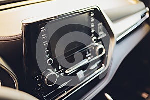 Leather car interior. Modern car illuminated dashboard. Luxurious car instrument cluster. Close up shot of automobile