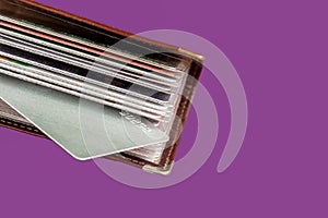 Leather Card holder wallet full of business cards on purple background