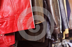 Leather clothes hanging on a rack in a flea market