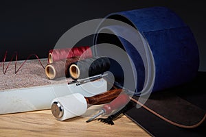 Leather crafting tools. Set of leather craftman tools with colorful threads photo