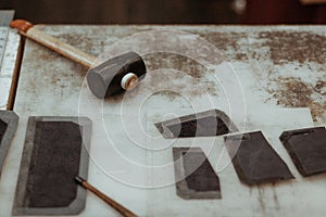 Leather craftmans work desk . Pieces of leather and working tools on a work table. Leather craft.