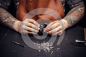 Leather Currier creating new leatherwork at his work area