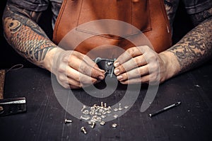 Leather Currier creating new leatherwork at his work area