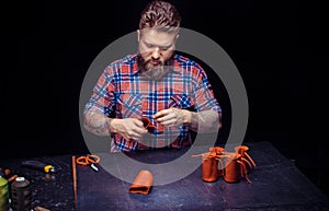 Leather Currier producing a leatherwork at his workshop